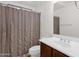 Bathroom featuring a shower-tub combo, a vanity with a sink, and neutral tile flooring at 5032 W Yearling Rd, Phoenix, AZ 85083