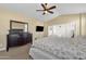 Bedroom featuring neutral walls and carpet, ceiling fan and a view to an adjoining bedroom through glass doors at 5032 W Yearling Rd, Phoenix, AZ 85083