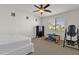 This bedroom has a ceiling fan, neutral colors, and a play area with a small table and an inversion table at 5032 W Yearling Rd, Phoenix, AZ 85083