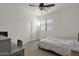 Bright bedroom with a ceiling fan, large window, and a cozy bed at 5032 W Yearling Rd, Phoenix, AZ 85083