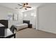 Cozy bedroom with ceiling fan, neutral carpet, large window, and stylish furnishings at 5032 W Yearling Rd, Phoenix, AZ 85083