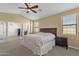 Bedroom featuring neutral walls and carpet, ceiling fan, and a view to an adjoining space through glass doors at 5032 W Yearling Rd, Phoenix, AZ 85083