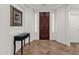 Elegant entryway with a dark wood door, beautiful tile flooring and white walls at 5032 W Yearling Rd, Phoenix, AZ 85083