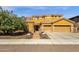 Stunning two-story home featuring a three car garage and lush front yard landscaping at 5032 W Yearling Rd, Phoenix, AZ 85083
