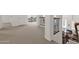 Upstairs hallway features neutral carpet, white walls, a decorative staircase and a peek at the downstairs fireplace at 5032 W Yearling Rd, Phoenix, AZ 85083
