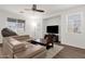 Comfortable living room featuring hardwood floors and a large television at 5032 W Yearling Rd, Phoenix, AZ 85083