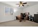 This office features neutral colored walls, a window for natural light, a fan and a large desk with built-in storage at 5032 W Yearling Rd, Phoenix, AZ 85083