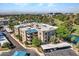 Aerial view of a multi-story condo complex located on a golf course and featuring nearby shopping and dining at 5124 N 31St Pl # 536, Phoenix, AZ 85016