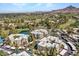 Aerial view of a neighborhood featuring lush landscaping, golf course, nearby lake, and mountain views in the distance at 5124 N 31St Pl # 536, Phoenix, AZ 85016