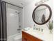 This bathroom features a tub and shower combo with a vanity, a dark wood mirror, and a single basin sink at 5124 N 31St Pl # 536, Phoenix, AZ 85016