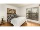 This bedroom offers a large window for lots of natural light with neutral walls and light hardwood floors at 5124 N 31St Pl # 536, Phoenix, AZ 85016