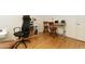This home office is equipped with a sleek desk, two wooden chairs, a rolling office chair and shelving for storage at 5124 N 31St Pl # 536, Phoenix, AZ 85016