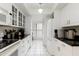 Well-lit kitchen featuring white cabinets and appliances with black countertops at 5124 N 31St Pl # 536, Phoenix, AZ 85016