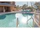 This outdoor pool features clear blue waters, palm trees, and comfortable lounge chairs for endless relaxation at 5124 N 31St Pl # 536, Phoenix, AZ 85016
