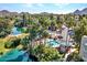An aerial view of a community pool surrounded by palm trees, lush vegetation, and mountain views at 5124 N 31St Pl # 536, Phoenix, AZ 85016