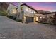 Beautiful home exterior with a spacious driveway and mature landscaping and stone facade at 5241 E Palo Verde Dr, Paradise Valley, AZ 85253