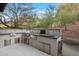 Outdoor kitchen with stainless steel grill, backsplash, and cooking area at 5241 E Palo Verde Dr, Paradise Valley, AZ 85253