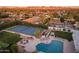 Beautiful aerial view of the home with a tennis court, pool, and outdoor entertainment area at 5532 E Crocus Dr, Scottsdale, AZ 85254