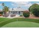 Beautiful backyard with a putting green and lush landscaping provides an outdoor oasis at 5532 E Crocus Dr, Scottsdale, AZ 85254
