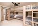 Bedroom featuring three sets of wooden bunk beds with patterned covers, and a ceiling fan at 5532 E Crocus Dr, Scottsdale, AZ 85254