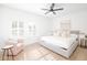 Bright bedroom featuring natural hardwood floors, shutters, and a sitting area with a pink chair at 5532 E Crocus Dr, Scottsdale, AZ 85254