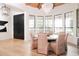 Elegant dining room featuring unique light fixtures, a table for six, and black framed windows at 5532 E Crocus Dr, Scottsdale, AZ 85254