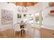 Bright dining area with floor to ceiling windows, wood floors, and a unique chandelier at 5532 E Crocus Dr, Scottsdale, AZ 85254