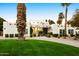 Stunning exterior view of the house featuring a manicured lawn and decorative palm trees at 5532 E Crocus Dr, Scottsdale, AZ 85254