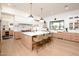 Modern kitchen with a large center island, wood cabinets, and state-of-the-art appliances at 5532 E Crocus Dr, Scottsdale, AZ 85254