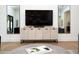Bright living room features a stylish display cabinet, wood flooring and contemporary decor creating an inviting space at 5532 E Crocus Dr, Scottsdale, AZ 85254