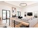 Spacious living room with ample seating, modern chandelier, and a fireplace to create a warm ambiance at 5532 E Crocus Dr, Scottsdale, AZ 85254