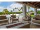 Covered patio with a pool view featuring a modern fire pit and comfortable outdoor furniture at 5532 E Crocus Dr, Scottsdale, AZ 85254