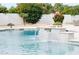 A close-up shot capturing the calming allure of a swimming pool with a charming tiled waterfall and lush greenery at 5532 E Crocus Dr, Scottsdale, AZ 85254
