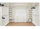 Organized walk-in closet with custom shelves and rods that optimizes the space with functionality and style at 5532 E Crocus Dr, Scottsdale, AZ 85254