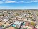 High-angle aerial showcasing a residential area with numerous homes, pools, and desert landscaping, capturing the neighborhood's layout at 6123 W Karen Lee Ln, Glendale, AZ 85306