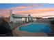 Inviting backyard with a sparkling pool, featuring a cozy patio area, privacy fence, and desert landscaping at 6123 W Karen Lee Ln, Glendale, AZ 85306