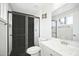 Modern bathroom showcasing a walk-in shower with black tiling, a white sink, and a sleek mirror at 6123 W Karen Lee Ln, Glendale, AZ 85306