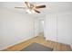 A cozy bedroom with a ceiling fan, closet and wood-look flooring, offering a comfortable and inviting space at 6123 W Karen Lee Ln, Glendale, AZ 85306