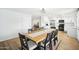 Bright dining area with a wooden table and seating for eight, seamlessly connected to the modern kitchen at 6123 W Karen Lee Ln, Glendale, AZ 85306