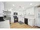 Modern kitchen with white cabinets, stainless steel appliances, and quartz countertops, offering a sleek and functional design at 6123 W Karen Lee Ln, Glendale, AZ 85306