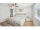 Bright main bedroom featuring a ceiling fan, neutral colors, and a stylish platform bed with side tables at 6123 W Karen Lee Ln, Glendale, AZ 85306