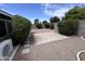 Landscaped backyard features pavers, gravel, and mature trees at 6132 E Decatur St, Mesa, AZ 85205