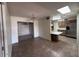 Open floorplan between the dining and kitchen spaces with tiled floor and plentiful lighting at 6132 E Decatur St, Mesa, AZ 85205