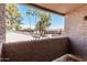 A stunning balcony view showcases the community pool and lush palm trees at 623 W Guadalupe Rd # 228, Mesa, AZ 85210
