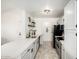 Updated kitchen boasts white cabinets, stainless steel appliances, quartz countertops, and stylish fixtures at 623 W Guadalupe Rd # 228, Mesa, AZ 85210