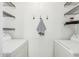The laundry room is spacious, featuring wire shelving and a washer and dryer at 623 W Guadalupe Rd # 228, Mesa, AZ 85210