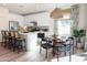 Bright kitchen with stainless steel appliances, white cabinetry, dining area, and decorative light fixture at 634 N Vine St, Chandler, AZ 85225