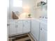 Well-lit laundry room features white cabinets, countertop space, and a modern washer and dryer at 634 N Vine St, Chandler, AZ 85225