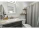 Neutral bathroom with modern fixtures, vanity, and shower with gray curtain at 6845 E Osborn Rd # D, Scottsdale, AZ 85251