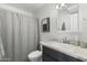 Clean bathroom with modern sink, fixtures, and gray shower curtain at 6845 E Osborn Rd # D, Scottsdale, AZ 85251